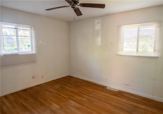 1515 Eastview Ave, Danville, IL 61832 - unfurnished room featuring wood finished floors, healthy amount of natural light, and baseboards