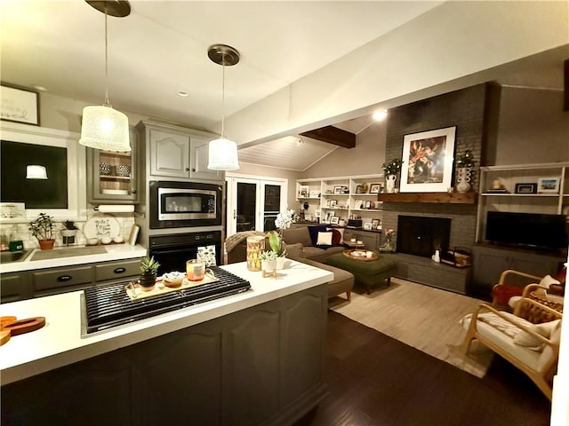 141 Hightide Dr, Decatur, IL 62521 - kitchen with oven, light countertops, gas cooktop, dark wood-type flooring, and glass insert cabinets