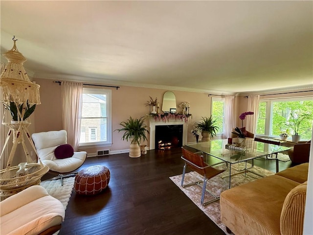 141 Hightide Dr, Decatur, IL 62521 - living room with wood finished floors, ornamental molding, a lit fireplace, and baseboards