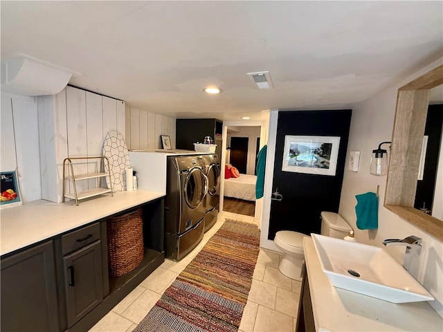 141 Hightide Dr, Decatur, IL 62521 - laundry room with separate washer and dryer, a sink, and light tile patterned flooring