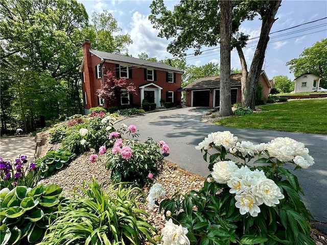 141 Hightide Dr, Decatur, IL 62521 - colonial home with a chimney, a garage, an outbuilding, and asphalt driveway
