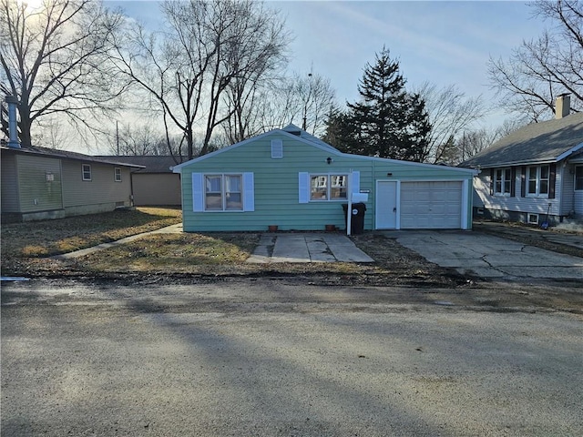 view of front of property with a garage and aphalt driveway