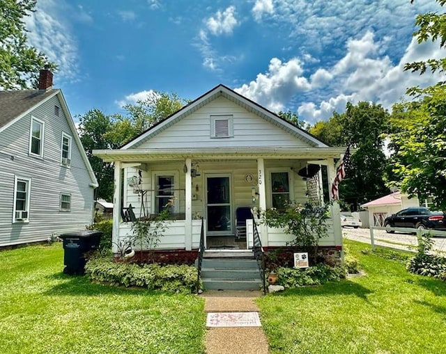 bungalow featuring a porch and a front yard