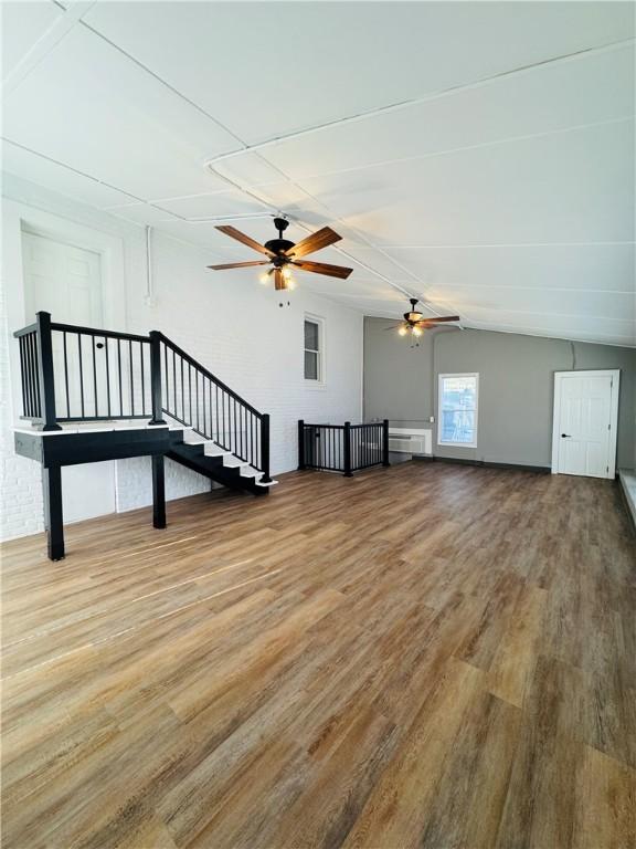 interior space with ceiling fan, lofted ceiling, and hardwood / wood-style floors