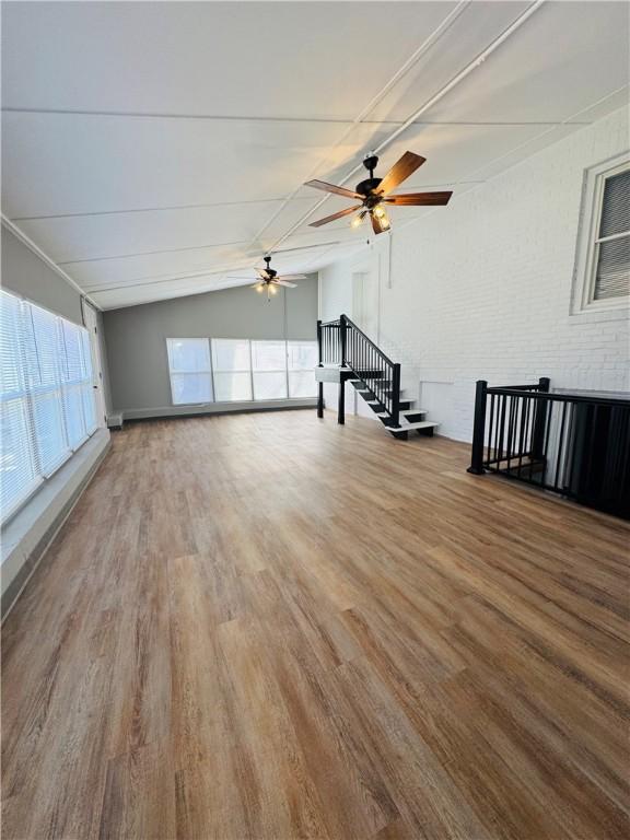 interior space with vaulted ceiling, hardwood / wood-style floors, and ceiling fan