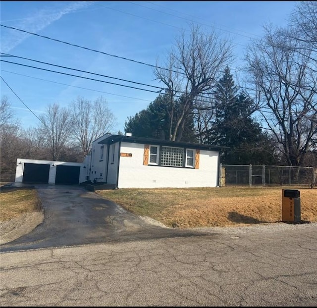 view of side of home with a garage and an outbuilding