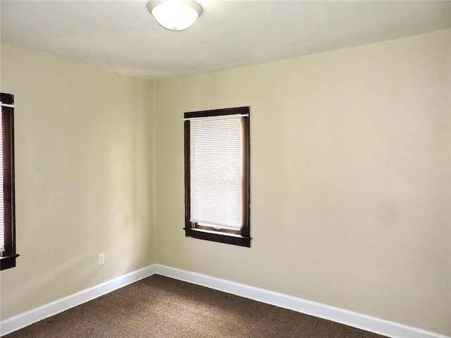 1511 Oak St, Danville, IL 61832 - empty room with dark carpet and baseboards