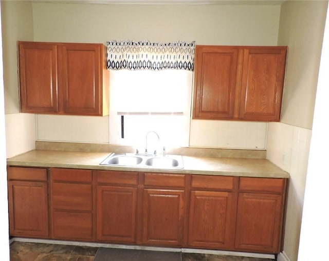 1511 Oak St, Danville, IL 61832 - kitchen featuring brown cabinetry, light countertops, and backsplash