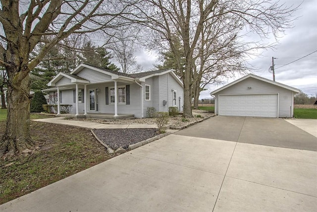 view of front of home with a detached garage, a porch, and an outbuilding