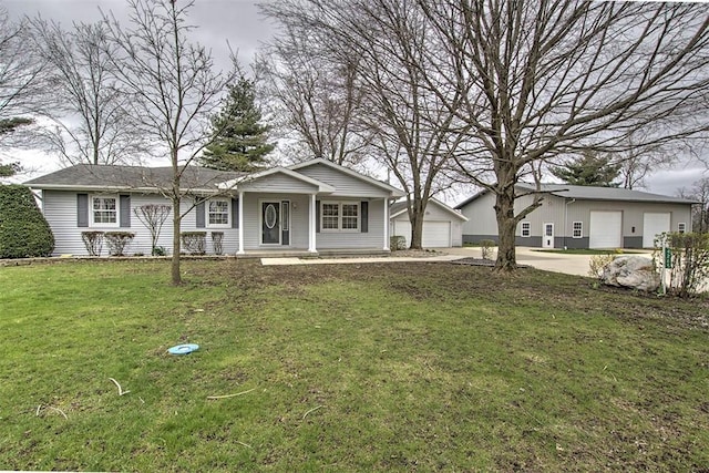 view of front of property featuring an outdoor structure, a porch, a garage, and a front lawn