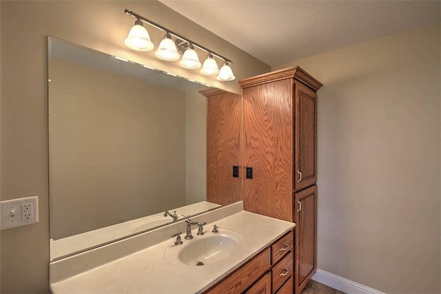 bathroom featuring baseboards and vanity