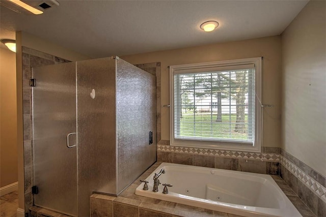 full bath with visible vents, a jetted tub, and a shower stall
