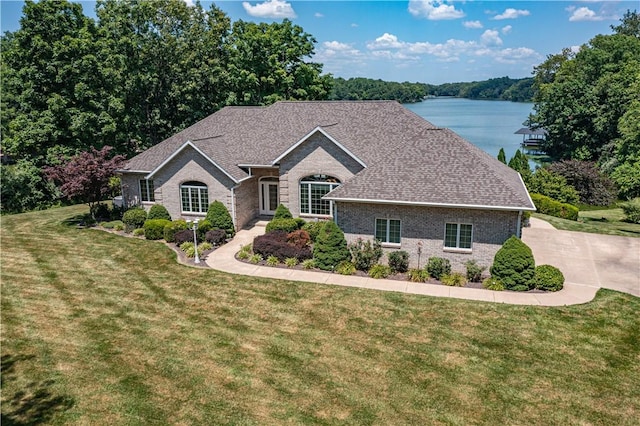 2928 Lakewood Dr, Vandalia, IL 62471 - view of front of property featuring brick siding, a front yard, a water view, and roof with shingles
