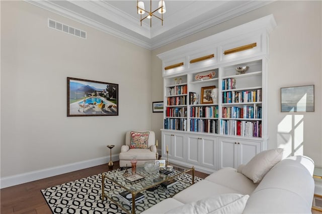 living area with baseboards, visible vents, ornamental molding, dark wood-style flooring, and a notable chandelier