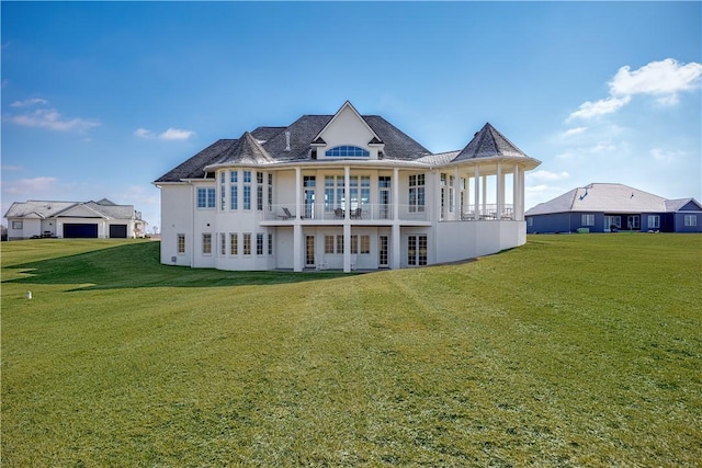 rear view of property featuring a yard