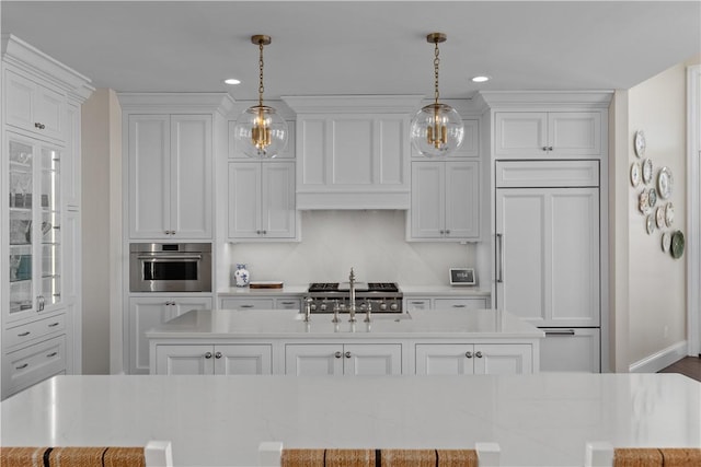 kitchen featuring glass insert cabinets, oven, decorative light fixtures, and paneled built in refrigerator