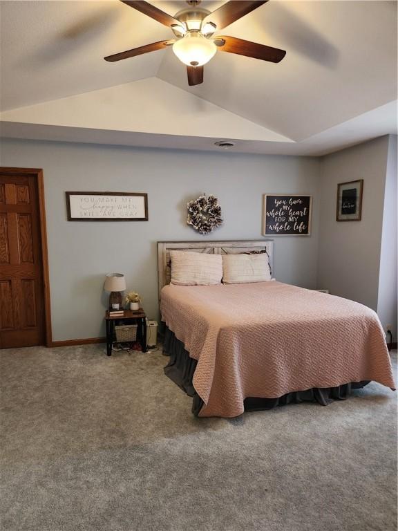 bedroom with vaulted ceiling, carpet flooring, and ceiling fan