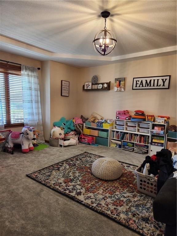 game room with a notable chandelier and carpet flooring