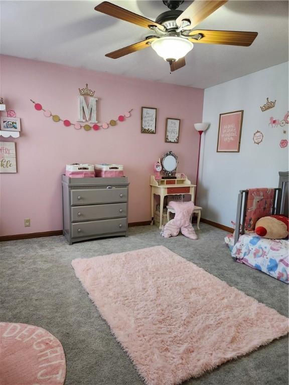 carpeted bedroom with ceiling fan and baseboards