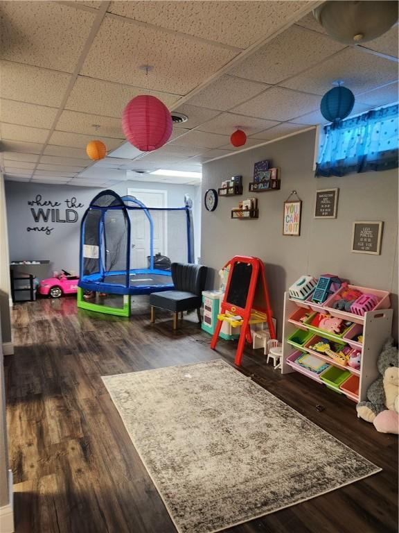 playroom with a drop ceiling and wood finished floors