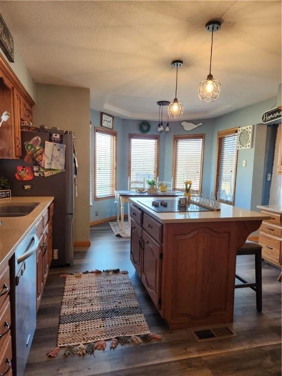 kitchen with dark wood finished floors, dishwasher, and light countertops