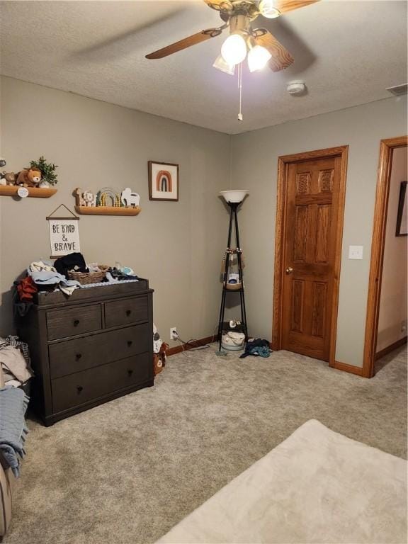 carpeted bedroom featuring a ceiling fan, baseboards, and visible vents