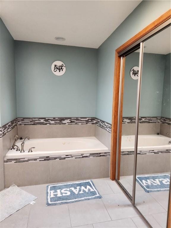 full bathroom featuring tile patterned flooring and a garden tub