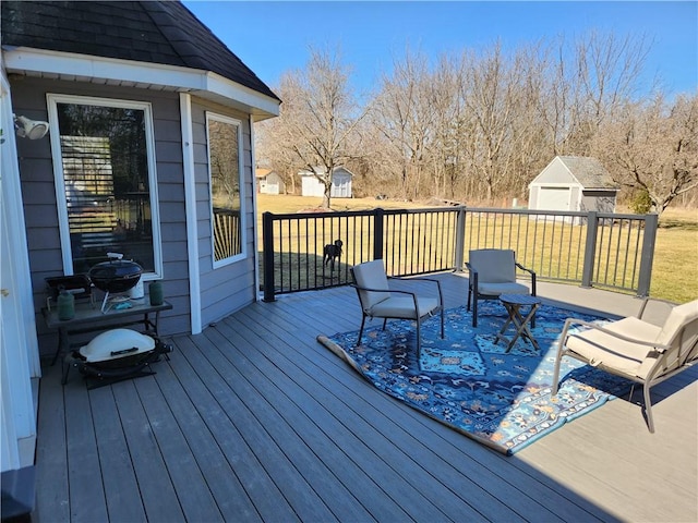 wooden deck featuring a yard and an outdoor structure