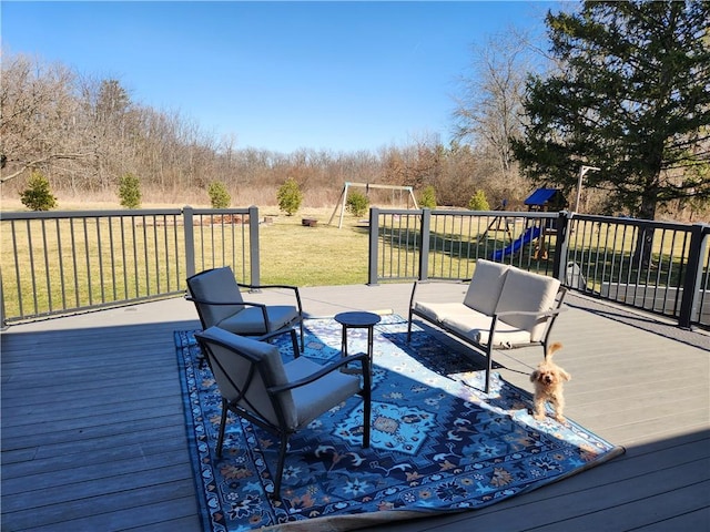 deck with a lawn, outdoor lounge area, and a playground