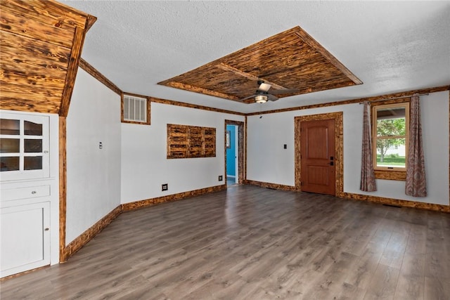 unfurnished living room featuring baseboards, visible vents, wood finished floors, and a textured ceiling