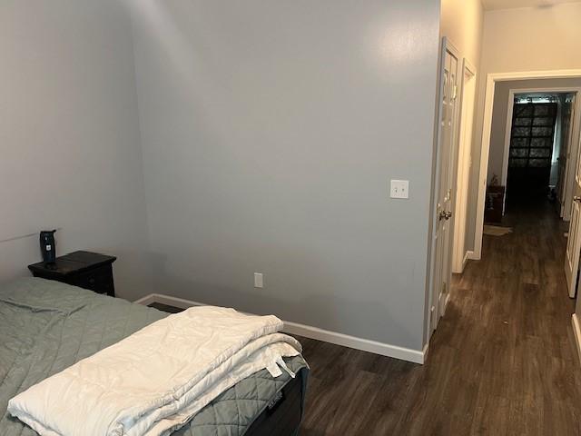 609 W Clinton Ave, Effingham, IL 62401 - bedroom with dark wood-style flooring and baseboards