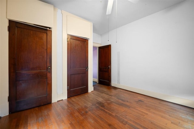 unfurnished bedroom featuring baseboards, a ceiling fan, and wood-type flooring