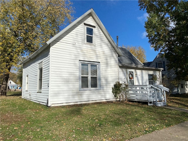 view of front facade with a deck and a front yard