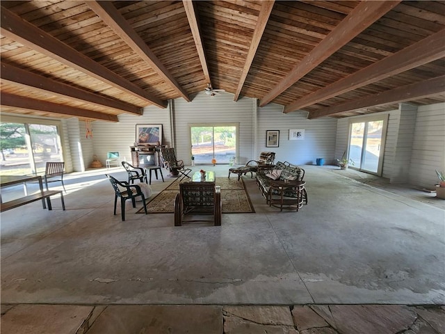 interior space featuring lofted ceiling, a healthy amount of sunlight, and concrete floors