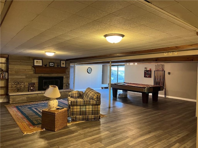 rec room with baseboards, a stone fireplace, wood finished floors, and billiards