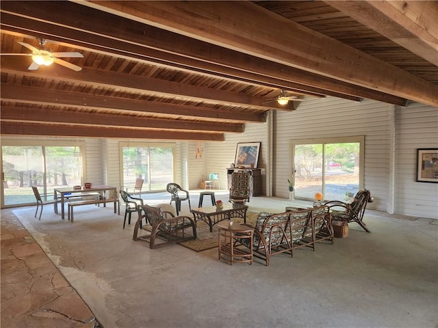 dining space featuring beam ceiling, concrete flooring, and ceiling fan