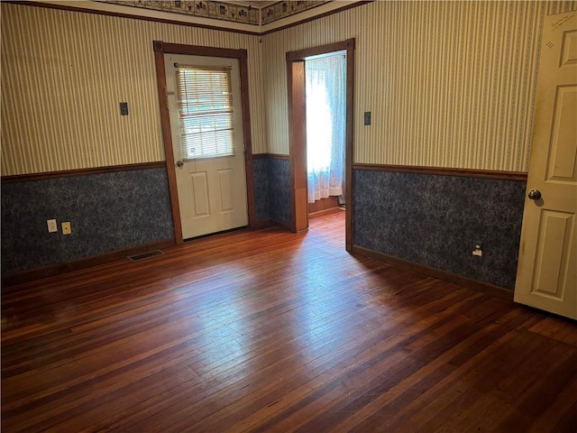 1524 Adams Ave, Charleston, IL 61920 - spare room featuring wallpapered walls, wainscoting, and wood-type flooring