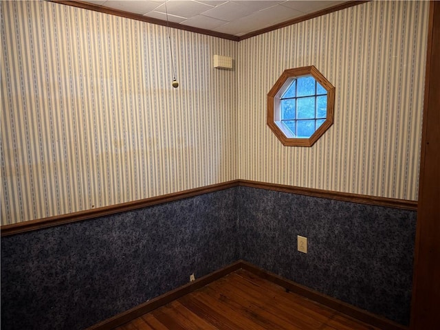 1524 Adams Ave, Charleston, IL 61920 - empty room featuring wallpapered walls, wood finished floors, ornamental molding, and wainscoting