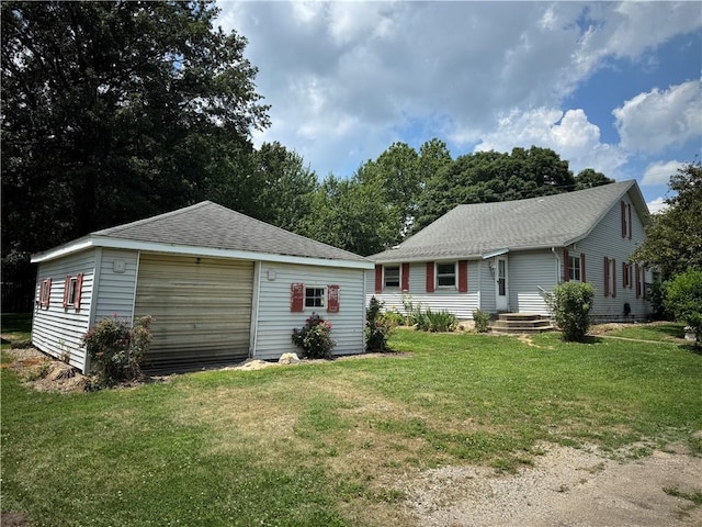 1524 Adams Ave, Charleston, IL 61920 - view of front of home featuring a detached garage, an outbuilding, a front yard, and a shingled roof