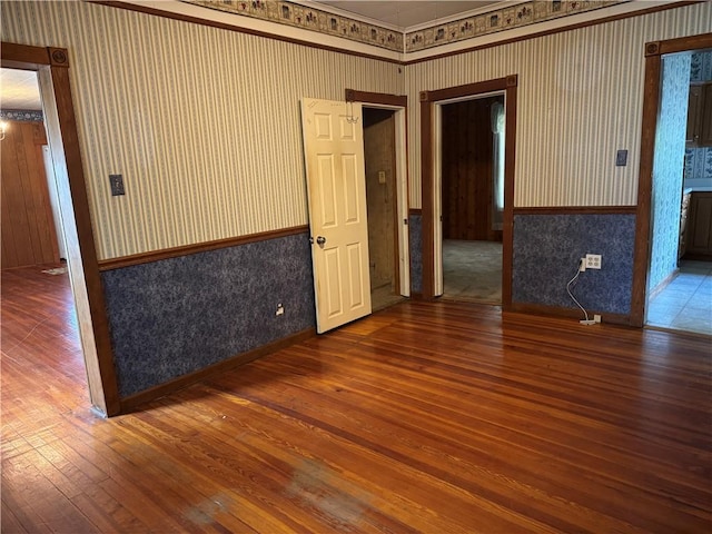 1524 Adams Ave, Charleston, IL 61920 - empty room with wallpapered walls, hardwood / wood-style flooring, and crown molding