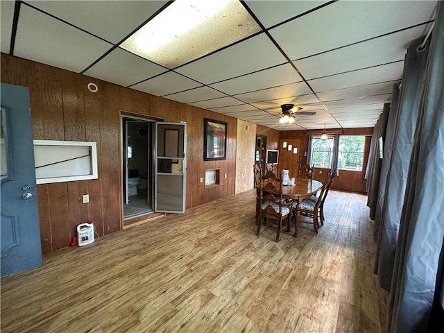 221 Celebration Ct, Oakwood, IL 61858 - dining space with a drop ceiling, wood walls, wood finished floors, and a ceiling fan