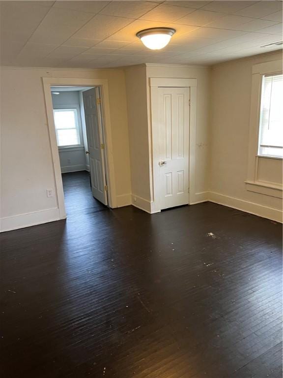 spare room with dark wood-type flooring