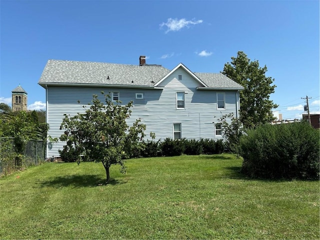 rear view of house with a lawn