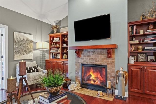 707 W Coolidge Ave, Charleston, IL 61920 - living room featuring a fireplace, wood finished floors, and vaulted ceiling