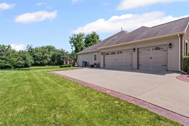 707 W Coolidge Ave, Charleston, IL 61920 - view of side of home with a lawn, concrete driveway, a garage, and roof with shingles