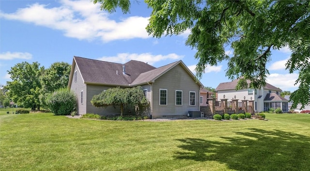 707 W Coolidge Ave, Charleston, IL 61920 - rear view of house with a yard and crawl space