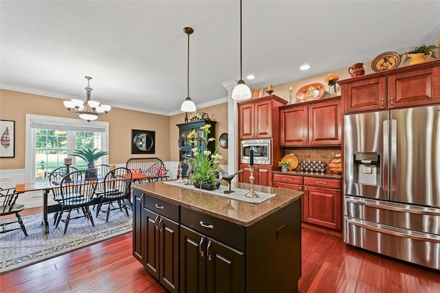707 W Coolidge Ave, Charleston, IL 61920 - kitchen featuring appliances with stainless steel finishes, a chandelier, a kitchen island, dark stone countertops, and hanging light fixtures