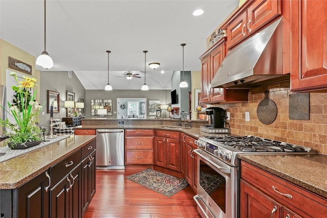 707 W Coolidge Ave, Charleston, IL 61920 - kitchen featuring appliances with stainless steel finishes, under cabinet range hood, a ceiling fan, a peninsula, and wood finished floors