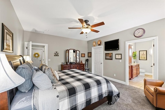 707 W Coolidge Ave, Charleston, IL 61920 - bedroom featuring light colored carpet, light tile patterned floors, a ceiling fan, and ensuite bath