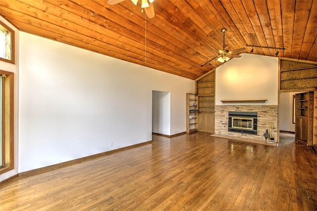 5959 Heritage Ln, Oakley, IL 62501 - unfurnished living room featuring a ceiling fan, wood ceiling, wood finished floors, a stone fireplace, and vaulted ceiling